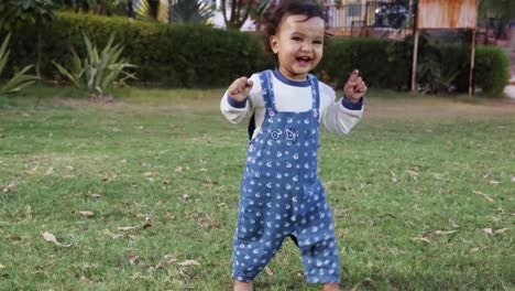 cute-toddler-trying-to-walk-at-park-green-grass-from-different-angle