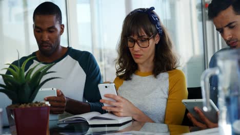 executives using mobile phone and digital tablet