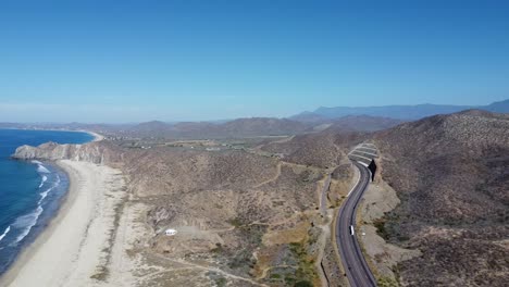 aerial view of a scenic coastline overlooking a coastal road along the secluded beach of cabo san lucas in baja california sur, mexico during an adventurous trip on a sunny day in summer