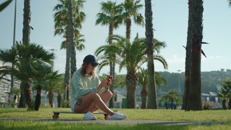 woman relaxing on a skateboard in a park