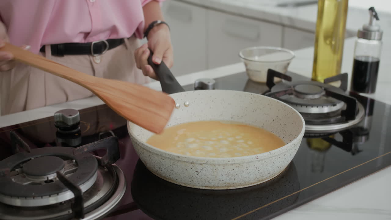 Woman Frying Scrambled Eggs on Pan at Home