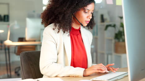 young call center agent typing on a computer