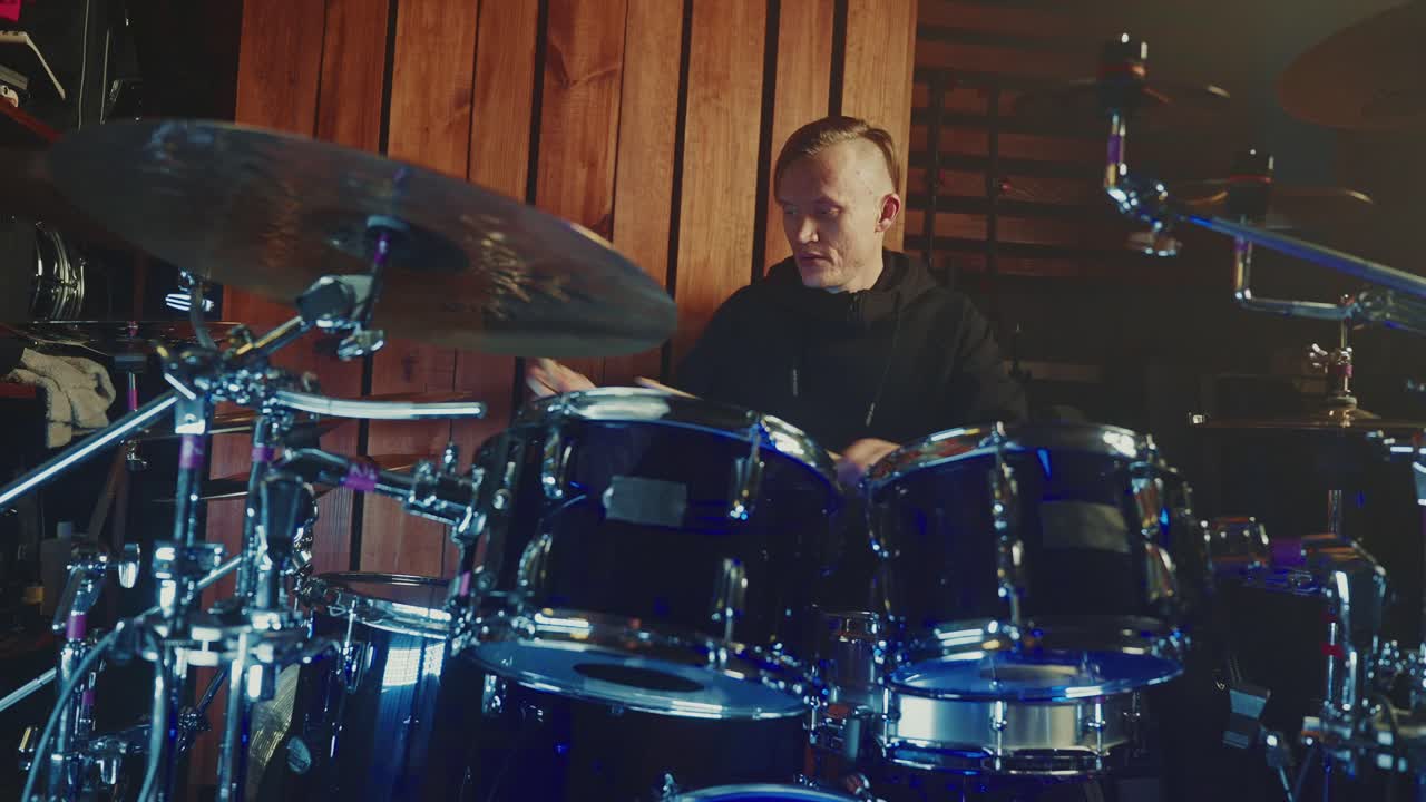 Drummer playing drums in a studio