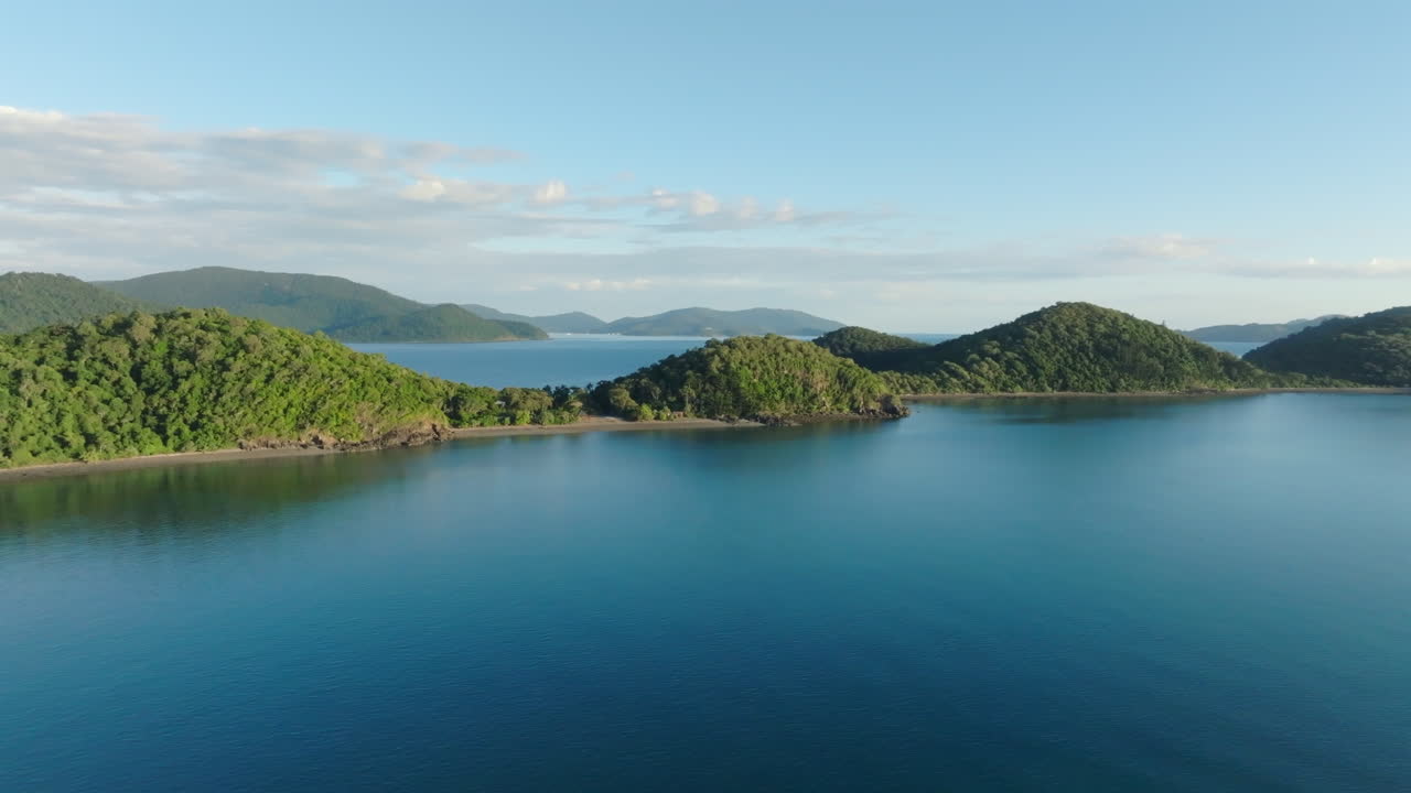 Drone shot descending towards the ocean near Long Island in the Whitsundays, QLD, Australia