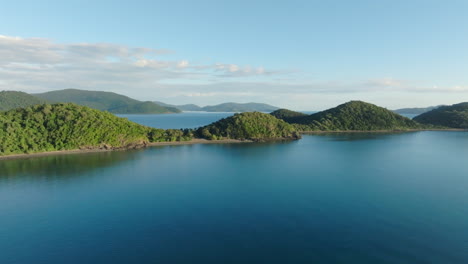 drone shot descending towards the ocean near long island in the whitsundays, qld, australia