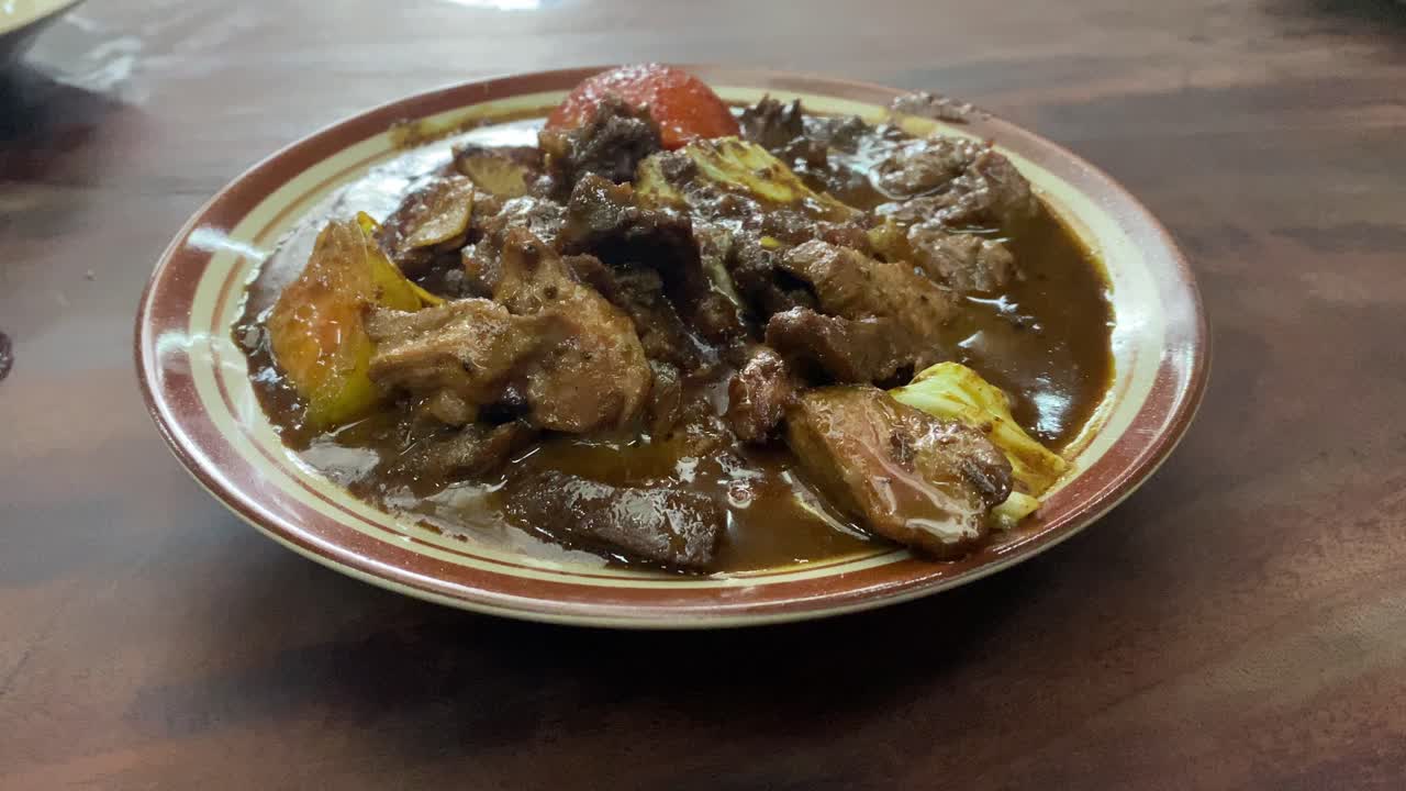 Tongseng delicious food served on a plate. Goat meat stew cooked with sweet soy sauce, coconut milk, sliced   cabbage, and tomatoes. Commonly found in Central Java, from Surakarta to Yogyakarta.