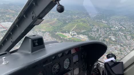 cockpit of helicopter flying over city