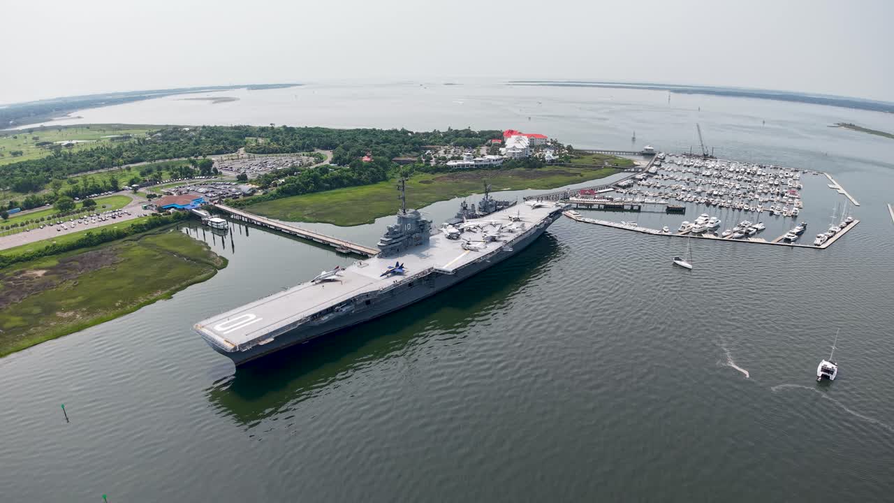 Aerial footage of the USS Yorktown aircraft carrier docked at Patriots Point Naval Maritime Museum in Charleston Harbor
