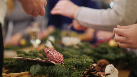 mom and daughter make christmas wreath at master class