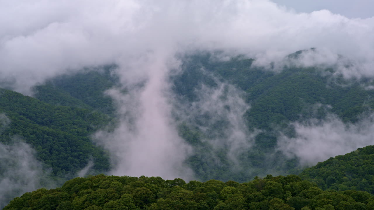 Drone view of mist weaving through the Smoky ridgelines