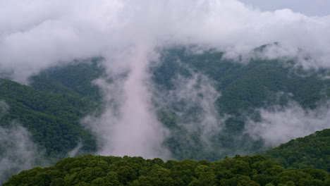drone view of mist weaving through the smoky ridgelines