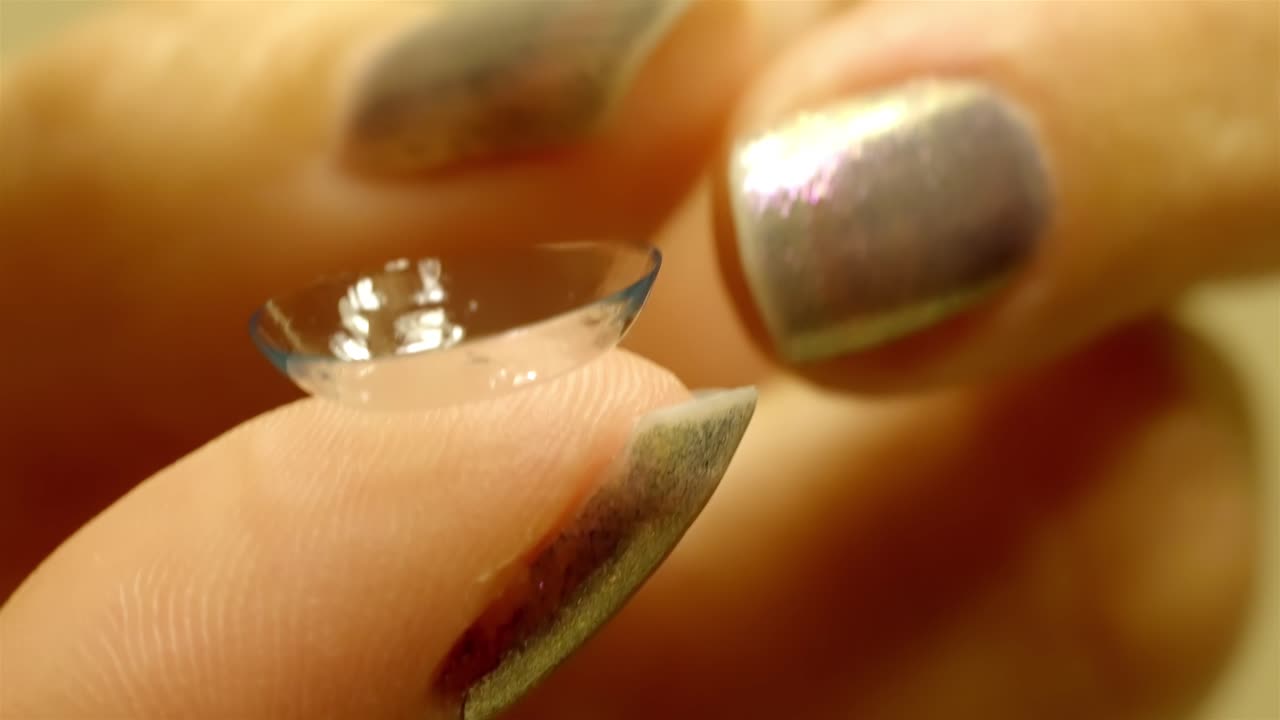 Close-Up View of Woman's Finger Holding a Corrective Vision Lens