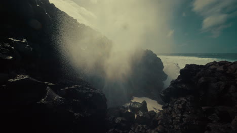 powerful ocean waves crashing against volcanic rocks