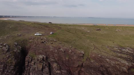 Car-driving-along-coastal-panoramic-road-on-cliffs-of-Punta-Ballena-peninsula-in-Uruguay