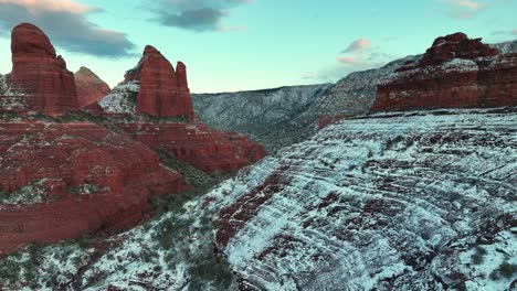 snowy hills of red sandstone rock formations in sedona, arizona, usa