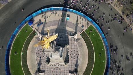 Aerial-view-March-8th-Women's-Day-march,-on-Paseo-de-la-Reforma,-Mexico-City,-Monument-view