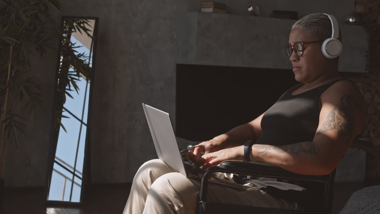 Woman in Wheelchair Typing on Laptop