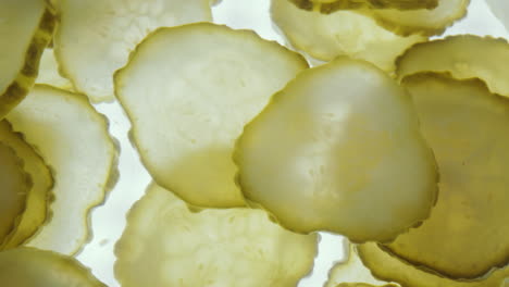 taking dill pickle slice with tweezers