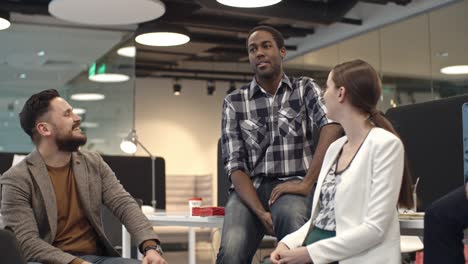 african businessman relaxing and chatting with colleagues