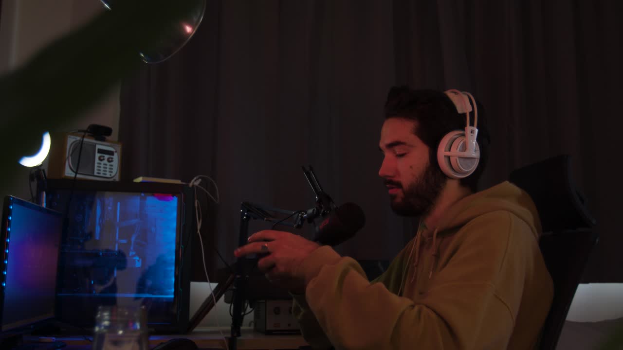 juegos masculinos con un pad de juegos y hablando por un micrófono mientras se transmite