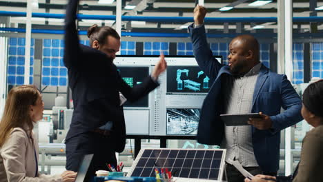 happy businessmen in solar panel plant celebrating increased sales, dancing