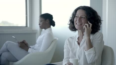 happy businesswoman talking by smartphone