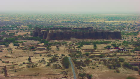 aerial flight over the the historically-significant derawar fort, enormous and impressive structure in the heart of the cholistan desert, located south of the city of bahawalpur, pakistan