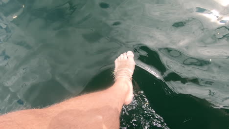 relaxing with my feet in the lake off a boat