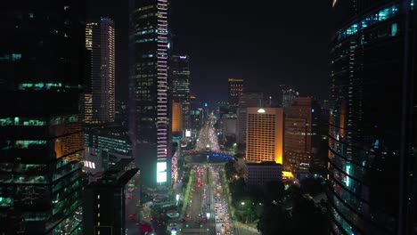 night time illuminated jakarta city downtown famous traffic street circle fountain aerial panorama 4k indonesia