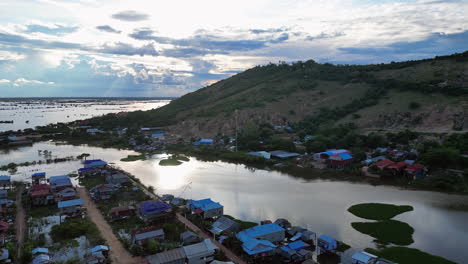 sun reflects off of glassy flood waters around cambodian swamp village near tonle sap lake