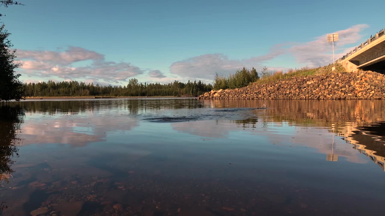 Skipping rocks across an Alaskan River, Sunny Evening.