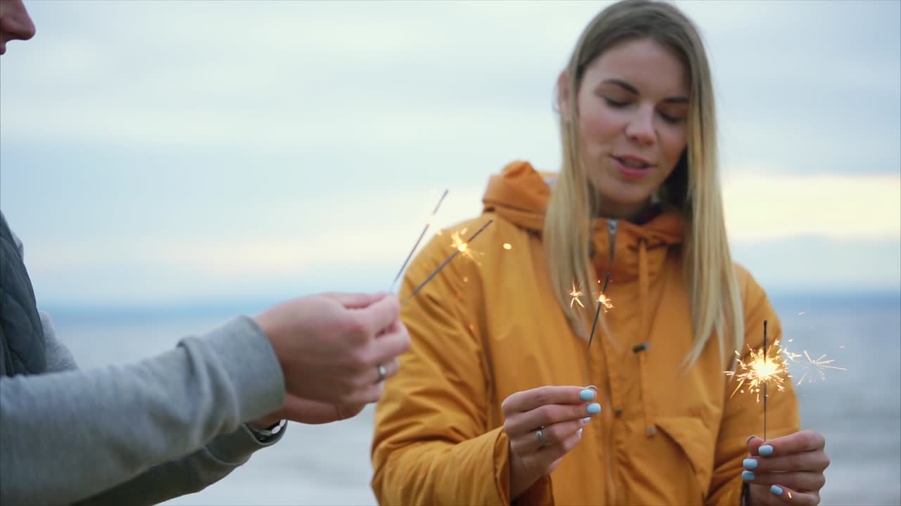Friends Celebrating at the Beach with Sparklers