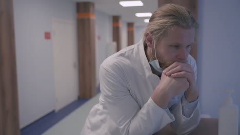 a young doctor with long, blond hair is very stressed out and exhausted after a difficult day of bad news