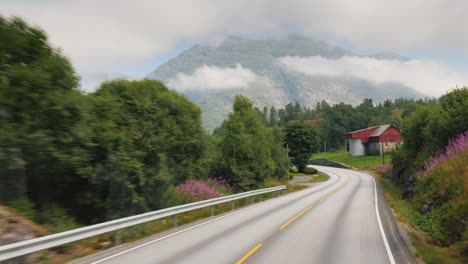 drive along the handsome road among the mountains of norway pov view from the bus window