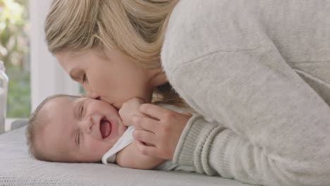 happy mother caring for baby at home loving mom gently kissing toddler soothing her child enjoying motherhood