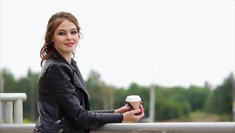 woman with coffee outdoors