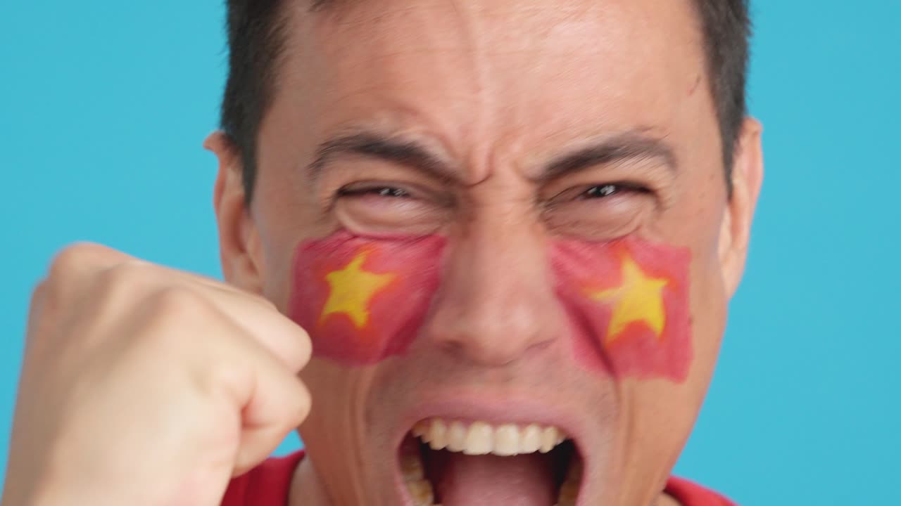 Close up of a man supporting vietnamese team