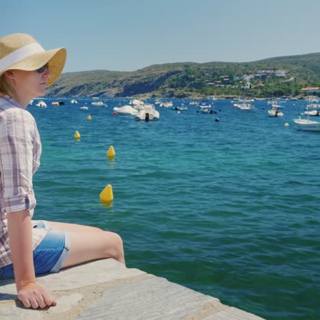 a woman rests by the sea near cadaques in catalonia 3