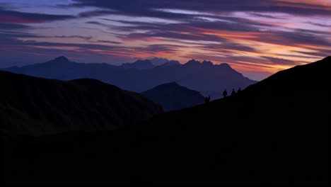 sunrise or sunset over mountain range with people