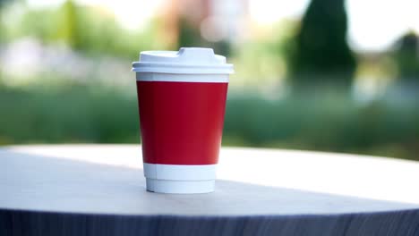 red coffee cup on a wooden table