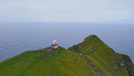 Kreisförmige-Drohnenaufnahmen-Des-Kallur-Leuchtturms-Auf-Der-Kalsoy-Insel-Auf-Den-Färöer-Inseln
