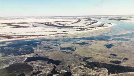 aerial view of a frozen river in winter