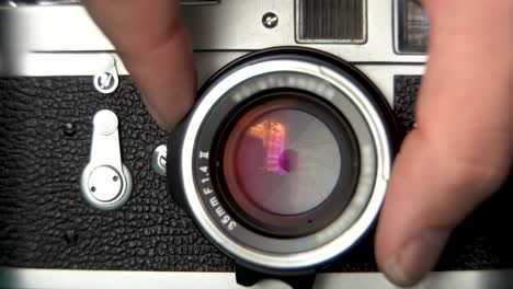 setting the aperture on leica m2 vintage camera lens, film photography footage, 4k close up shot