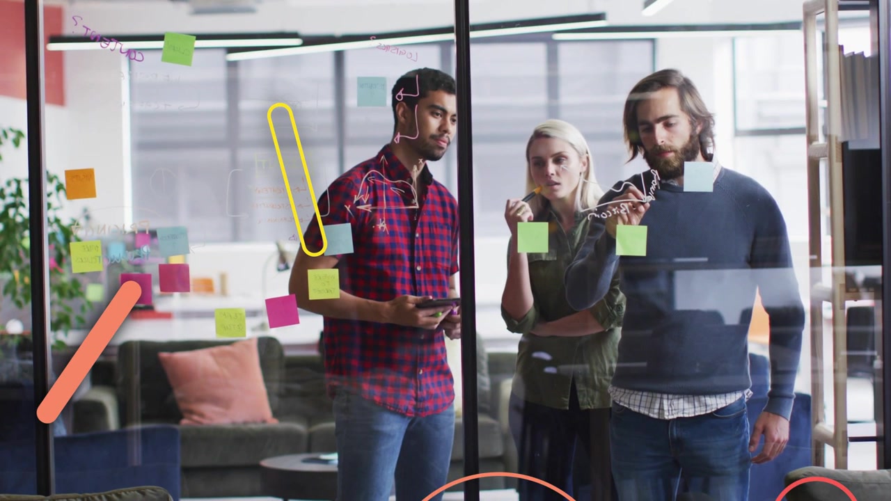 Team pointing and writing on glass, causing animated shapes expanding, revealing notes for business