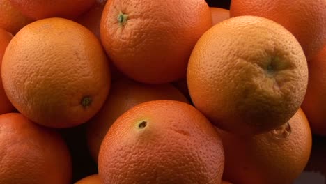 A-pile-of-oranges-sits-on-a-table