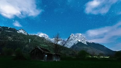 timelapse night sky with fast-moving clouds over the alps