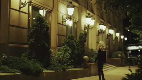 Female-person-walking-street-alone-at-night-in-modern-city-lights.