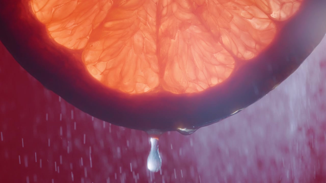 Goccia d'acqua che cade da una fetta di pompelmo con spruzzi d'acqua sullo sfondo