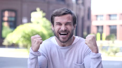 handsome man celebrating success  gesture in offcie