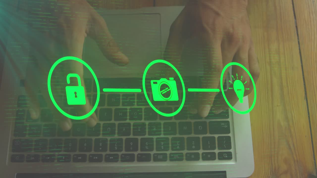 animación de iconos conectados, vista aérea de un hombre biracial escribiendo en el teclado de una computadora portátil